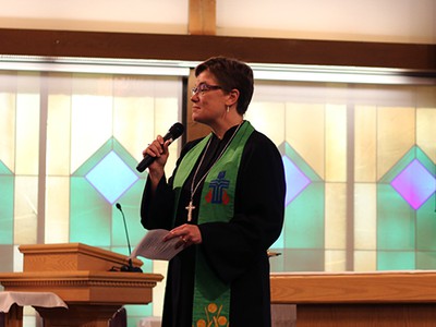 Rev. Cindy Kohlmann speaks at Travis Air Force Base in California. Photo by Rick Jones.