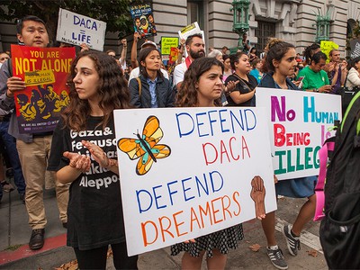 Protesters hold various signs and banners at a DACA rally in San Francisco September 5, 2017.