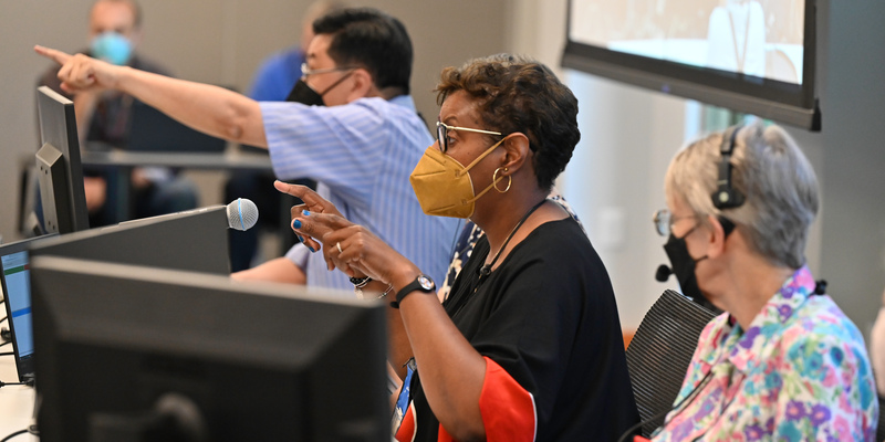 James Tse, Christi Scott Ligon, and Tricia Dykers-Koenig settle some final details before the Committee on Bills and Overtures meeting at the end of second day of the 225th General Assembly of the Presbyterian Church (U.S.A.) on June 19, 2022, at the Presbyterian Center in Louisville, Kentucky. (Photo by Rich Copley) 