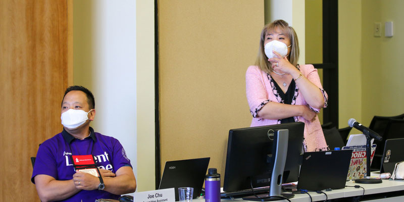 Committee assistant Joe Chu (left) and moderator Frances Lin (right) of the Presbytery of San Diego watch presentations from small groups during the Committee on Ecumenical and Interfaith Engagement meeting on June 27, 2022, at the 225th General Assembly of the Presbyterian Church (U.S.A.) in Louisville, Kentucky. (Photo by Randy Hobson) 