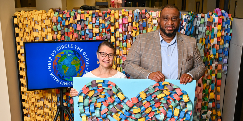 Ruling Elder Elona Street-Stewart and the Rev. Gregory Bentley with the “Links of Love” display.