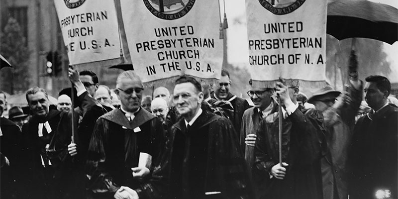 Moderators Harold R. Martin and Robert N. Montgomery shake hands during the march celebrating the union