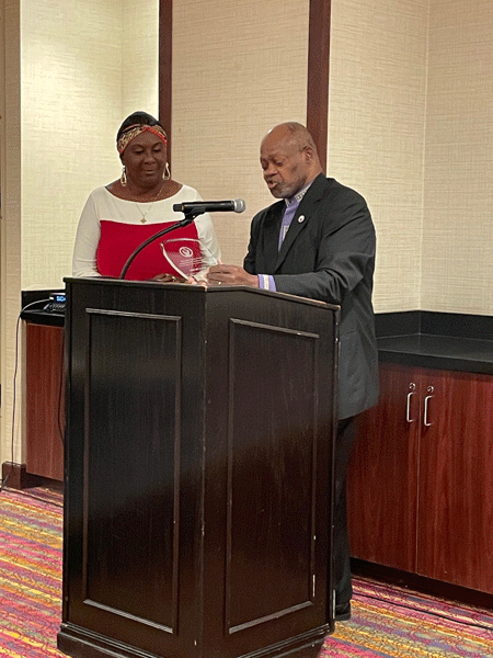 The Rev. Dr. Charles C. Heyward Sr. presents Jewel McCrae