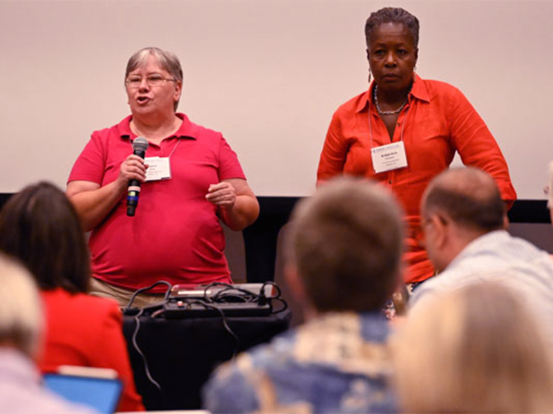 A Corp Board members JoAnne Sharp and Bridget-Anne Hampden, left to right, speak to a Big Tent group Thursday that gathered to talk about the future of translation services. (Photo by Rich Copley)