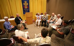 Photo of a group of people seated in a circle