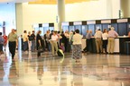 A photo of people standing in line at booths