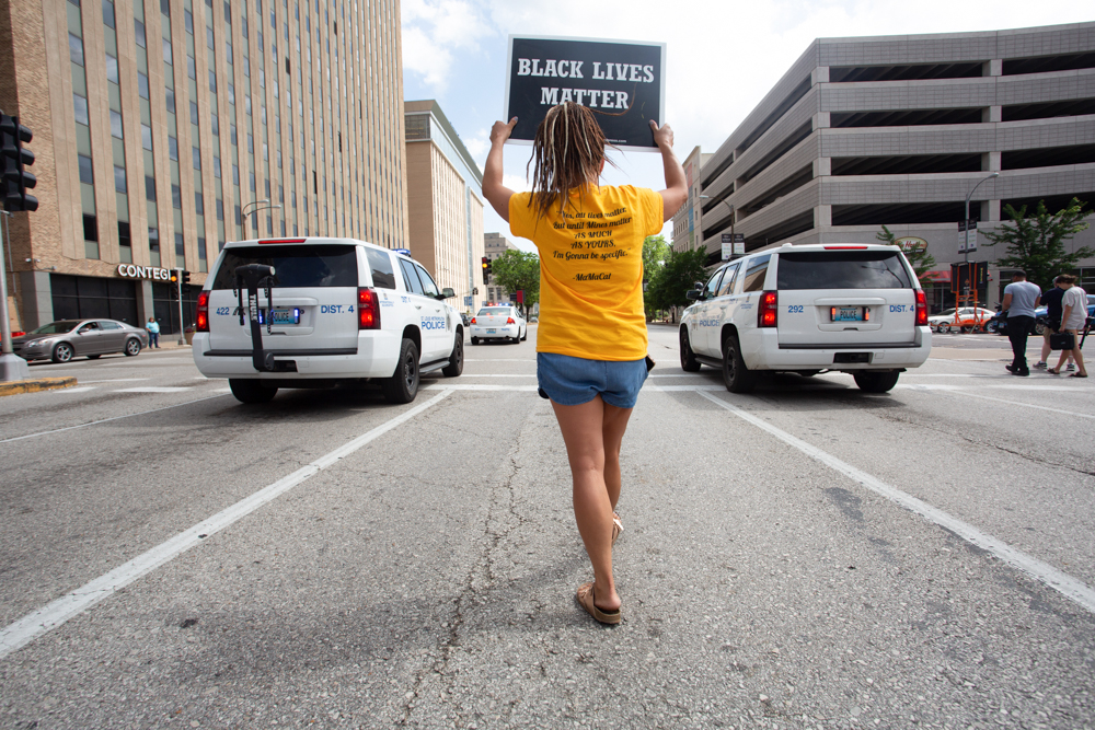 Rally participant holds up "Black Lives Matter" sign