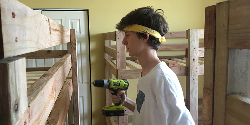 David Meeks of Sardis Presbyterian Church in Charlotte, puts together bunk beds for the church’s Hands and Feet project. Photo by Chris Keating