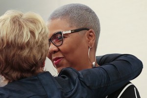 Katharine Henderson and Traci Blackmon embrace after Auburn Seminary breakfast