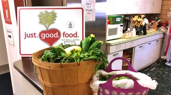 Setting up the garden bounty for a nutrition cooking demonstration and veggie give away at BayView Community Center's Pantry program.