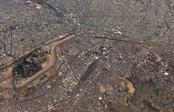 The Rio Grande River running through the middle of the picture separates Juarez, Mexico (top) and El Paso, Texas (bottom). Taken from 36,000 feet looking south.