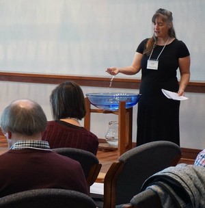 Pastoral resident Cyndi Wunder at the baptismal font during the confession and pardon, at the Small Church Residency commissioning worship service.