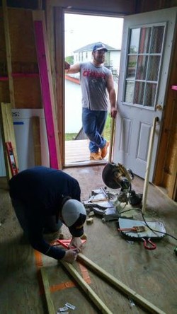 Volunteers from Ukirk-Missouri prepare framing for a rehabilitated home on Clouet St. in New Orleans.