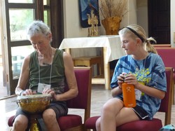 Samantha Bennett (right) watches as Dariel Blackburn tries her hand at the drum during an afternoon jam session.