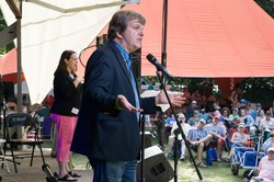 Fr. John Dear, activist and nonviolent peacemaking educator, addresses the crowd following morning worship at the Wild Goose Festival in Hot Springs, N.C. 