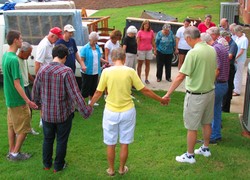 Furniture ministry volunteers from First Presbyterian Church of Burlington pray before beginning their work.