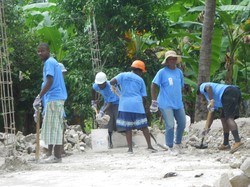 Work crews in Haiti clear rubble from a home outside of Léogâne