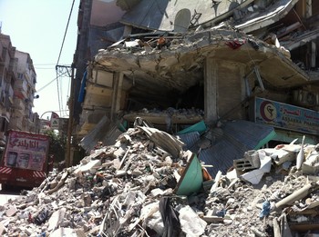 A toy truck hangs precariously off the roof of a building destroyed during shelling in Shuja'iyyia, in the neighborhood surrounding the hospital and one of the areas most heavily hit. 