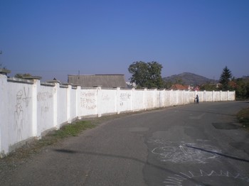 A wall, recently constructed around a Roma “camp,” is meant to keep passing motorists from getting distracted, officials say.