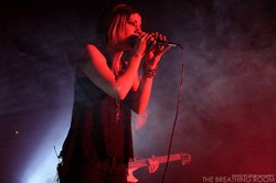 A woman singing on a stage.