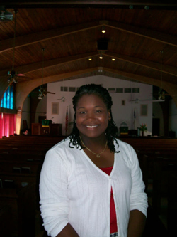 CC Armstrong standing in a church, smiling.