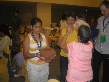 Participants in the CLAI General Assembly renew their baptism vows during morning prayers.