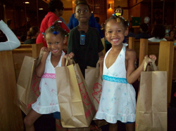 Two young girls holding school supplies