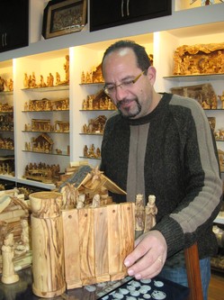 Bethlehem souvenir-shop owner Jack Giacaman displays nativity scenes, complete with Israel's Separation Barrier/Wall.