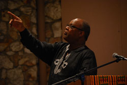 The Rev. Sterling Morse speaking from a lectern and pointing.