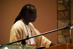 The Rev. Mark Lomax speaking from a lectern.