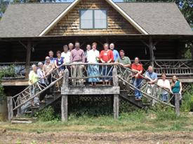 A group of people standing on two sides of stairs in front of a building