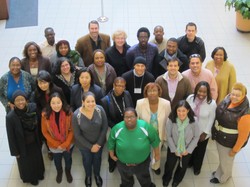 A group of people standing in an atrium.