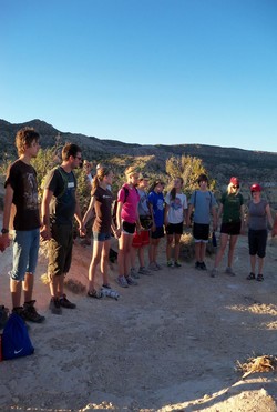 Young people stand in a line and hold hands