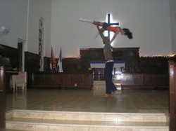 A male dancer lifts a female dancer in the air