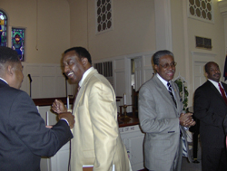 A group of men in suits in front of a church.