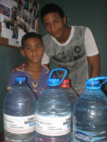 Two neighborhood residents pick up fresh water.