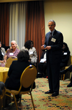 The Rev. Michael Kinnamon, standing and speaking to a seated audience in a room.