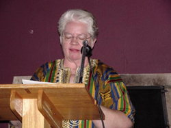 A woman speaking from a lectern.