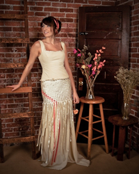 A young woman standing in a wedding dress.