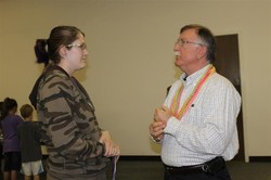 The Rev. Randy Branson speaks with a parishioner.