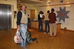 The Rev. Ray Masterson carries a guest's bags.