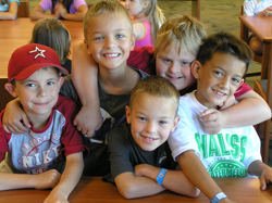 A group of kids together, smiling.