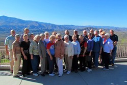 A group of people in front of mountains