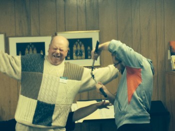 Jed Cauffman receives a trim during a skit about pruning. The pruner is his son Curtis.