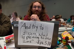 Kyle Combs posts his hopes on his laptop at the 221st General Assembly.