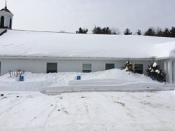 Heavy snow blankets the grounds of Windham Presbyterian Church in New Hampshire.