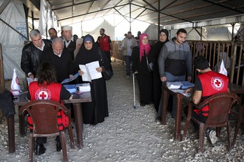 Syrian refugees line up to receive aid for the winter from the U.N. refugee agency in Tripoli, northern Lebanon, on Nov. 18, 2015.