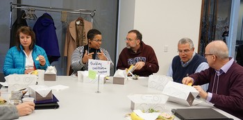 Conference participants gather in self-guided 'Unconference' groups over lunch to discuss topics related to interfaith leadership.