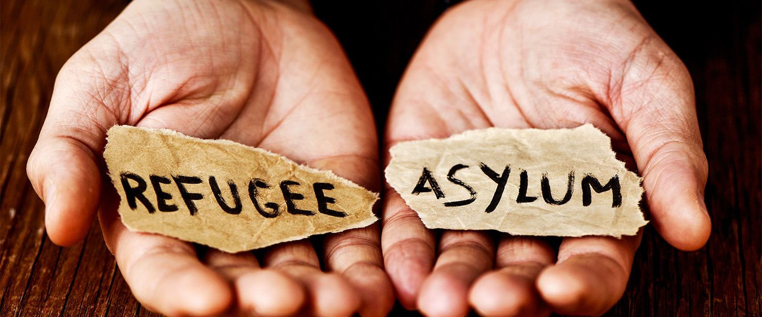 Image of hands with words Aylum and Refugee.