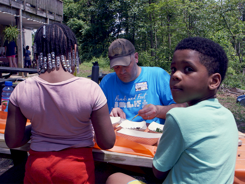 Andrew Yeager-Buckley, who oversees the Hands and Feet initiative, participates in craft activities during a visit to Baltimore earlier this year. Photo by Randy Hobson.